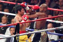 Manny Pacquiao, left, and Floyd Mayweather Jr. mix it up in the second round of their welterwei ...