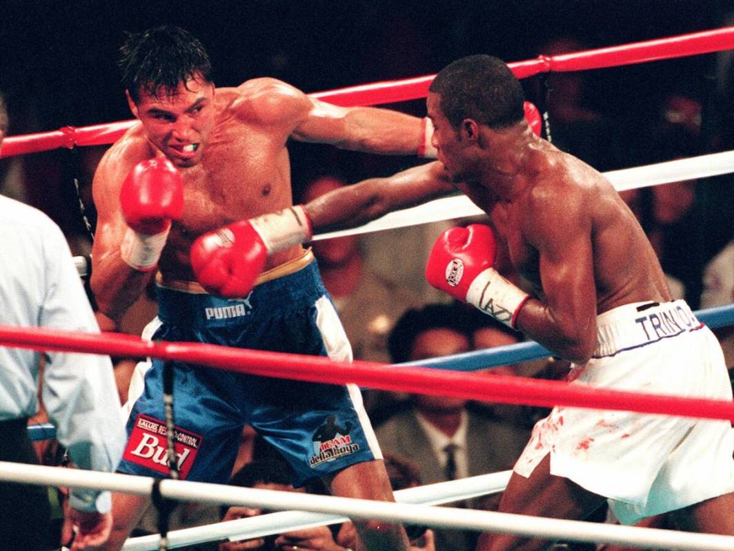 Oscar De La Hoya backs away after Felix Trinidad lands a right hand at Mandalay Bay on Saturday ...