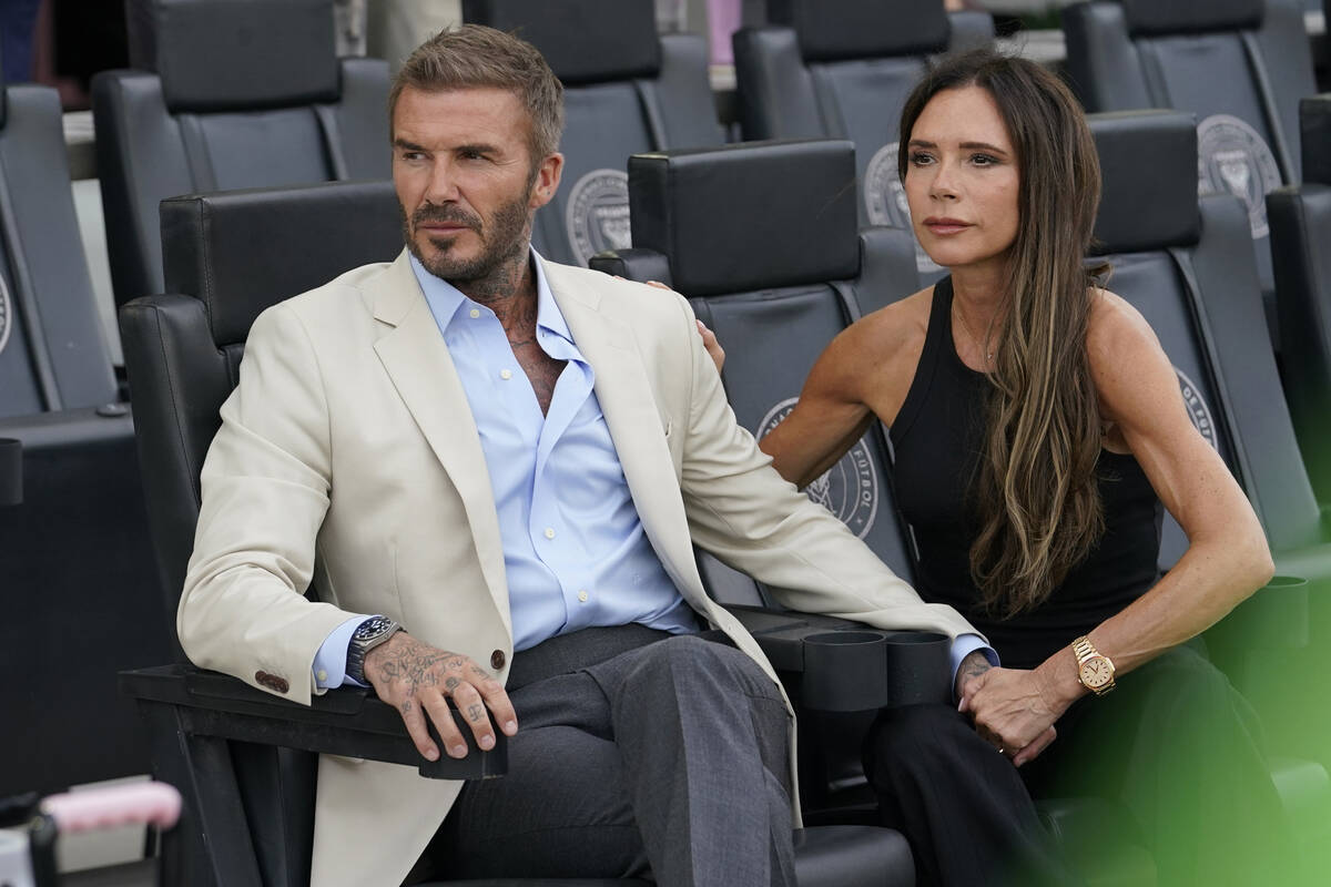 David and Victoria Beckham wait for the start of the Leagues Cup soccer match between the Inter ...