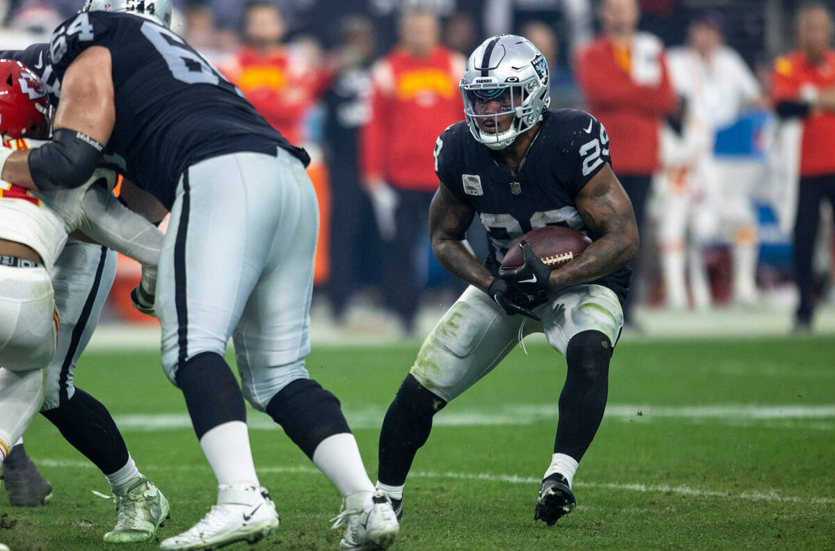 Raiders running back Josh Jacobs (28) looks for room to run against the Kansas City Chiefs duri ...