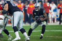 Raiders running back Josh Jacobs (28) looks for room to run against the Kansas City Chiefs duri ...