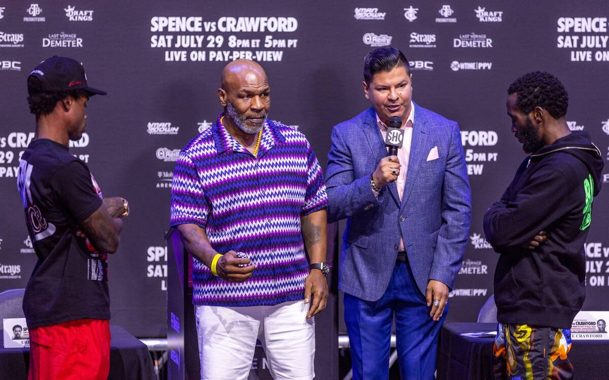 Mike Tyson readies to flip a coin with commentator Ray Flores for boxers Errol Spence Jr. and T ...