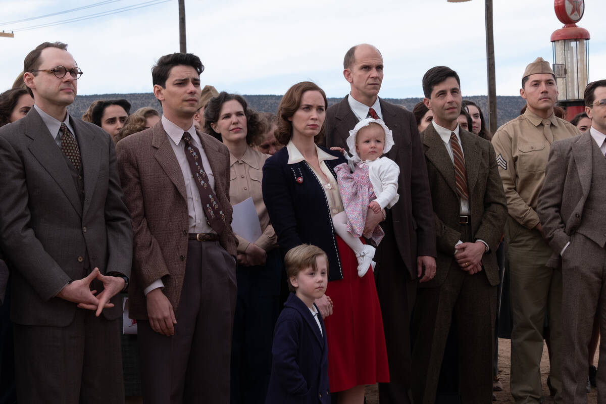 Kitty Oppenheimer (Emily Blunt) holds the hand of Peter Oppenheimer, Dorothy Oppenheimer Vander ...