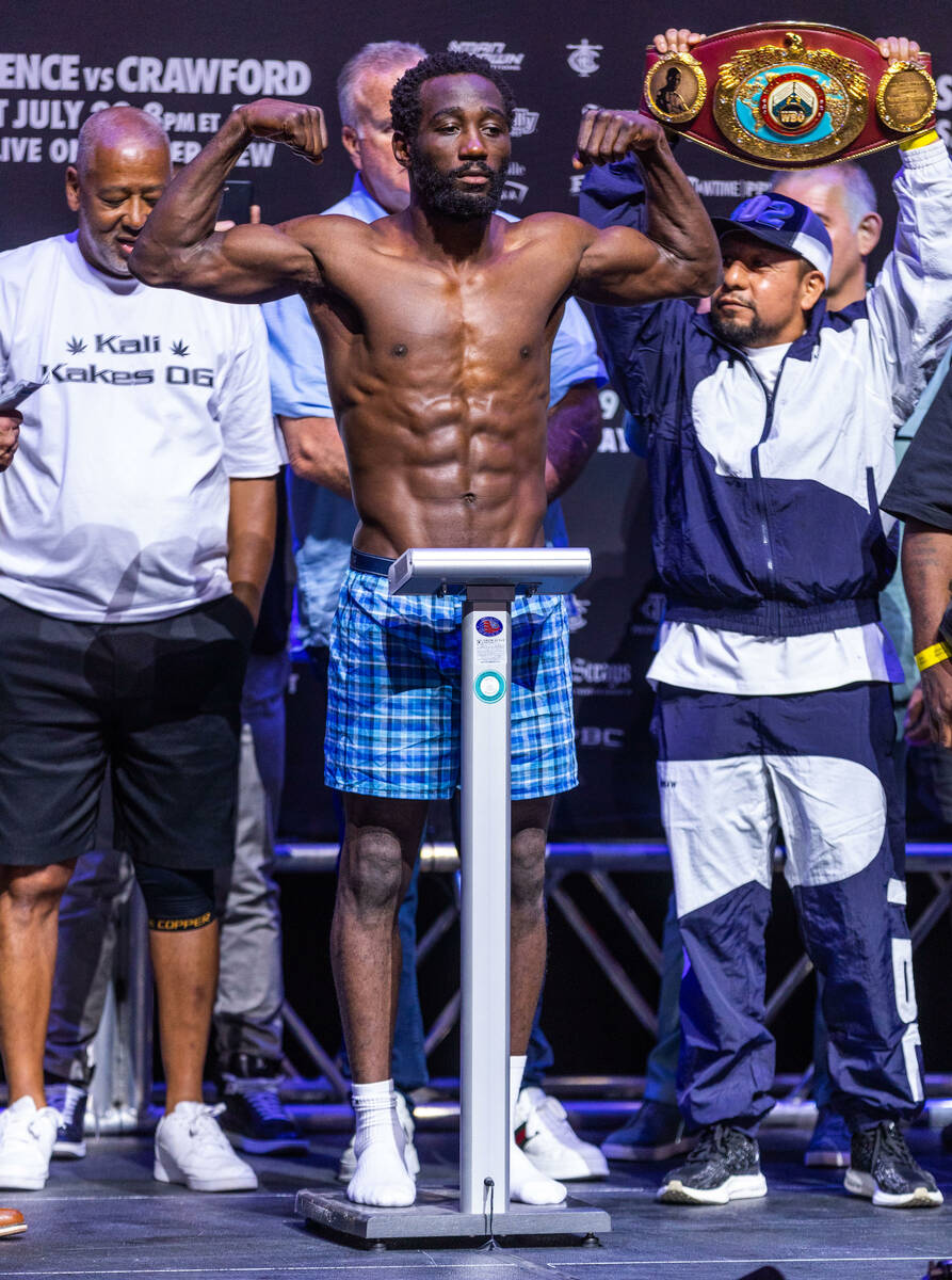 Boxer Terence Crawford flexes while on the scale during his weigh-in ahead of the fight against ...