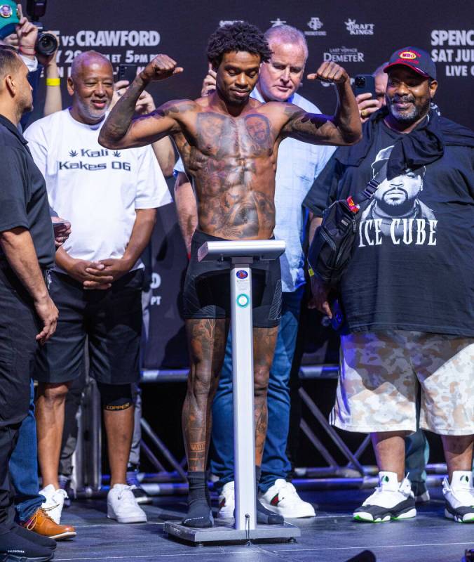 Boxer Errol Spence Jr.,flexes while on the scale during his weigh-in ahead of the fight against ...