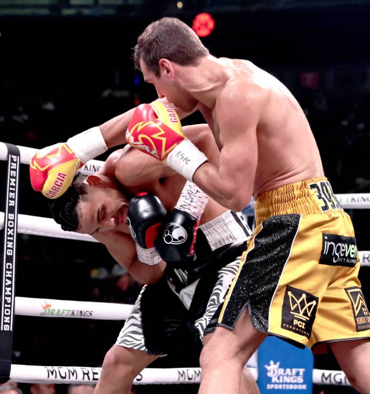 Boxer Yoenis Tellez takes a glancing punch to the head from Sergio Garcia during round 1 in a s ...