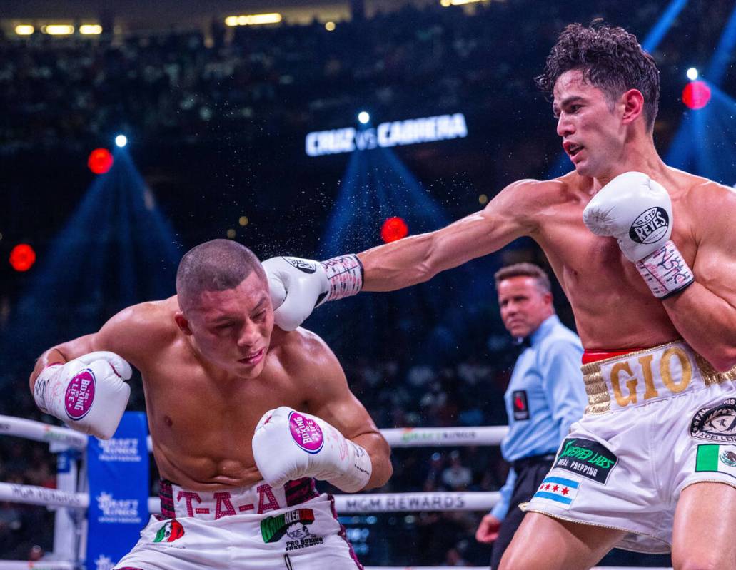 Isaac Cruz takes a punch from Giovanni Cabrera in round 1 during world welterweight, WBC Silver ...