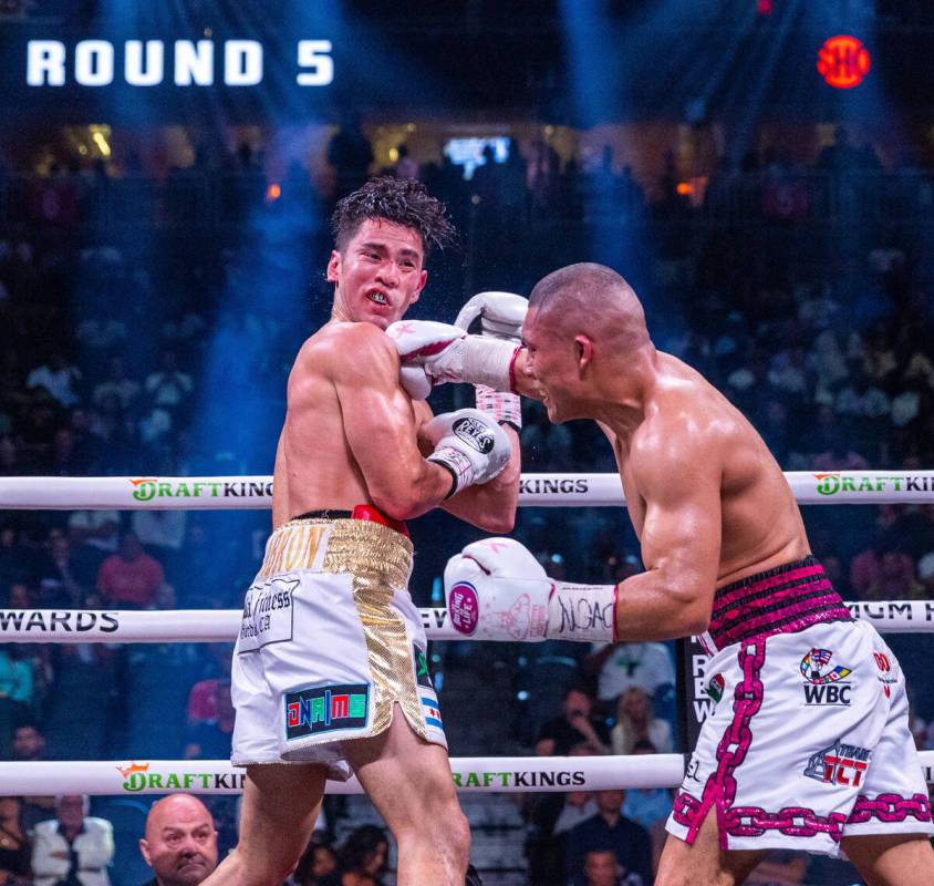 Giovanni Cabrera takes a punch to the chin by Isaac Cruz in round 5 during world welterweight, ...