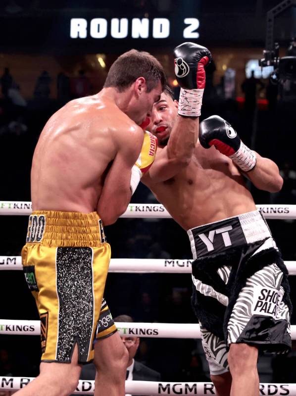 Boxer Yoenis Tellez, right, sends an uppercut past the head of Sergio Garcia during round 2 in ...