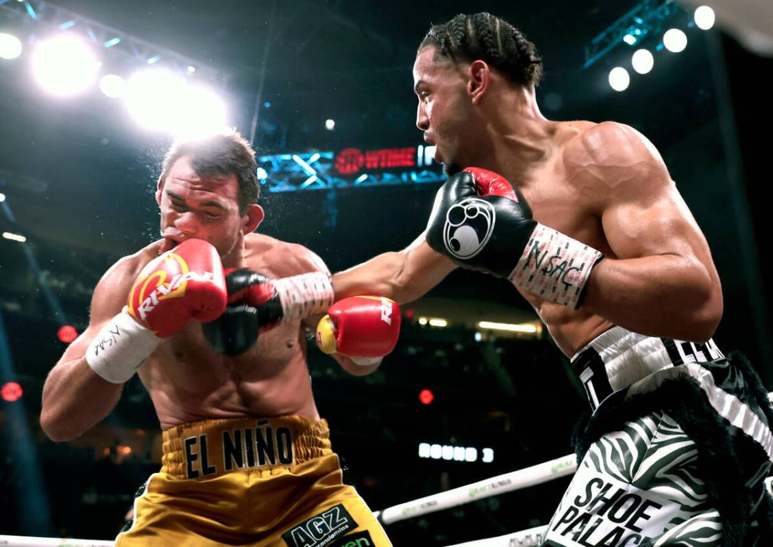 Boxer Yoenis Tellez, right, with a shot to the chin of Sergio Garcia during round 3 in a super ...