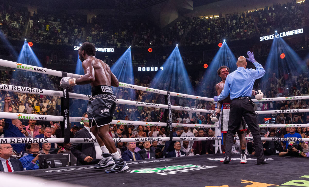 Terence Crawford celebrates his win over Errol Spence Jr., as the referee steps in on round 9 ...