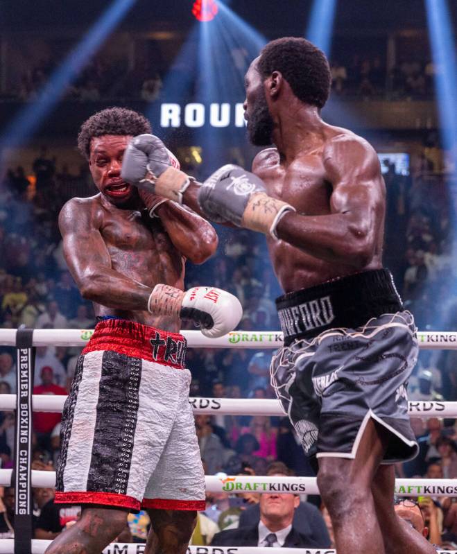 Errol Spence Jr., takes another punch to the face from Terence Crawford in round 7 during an un ...