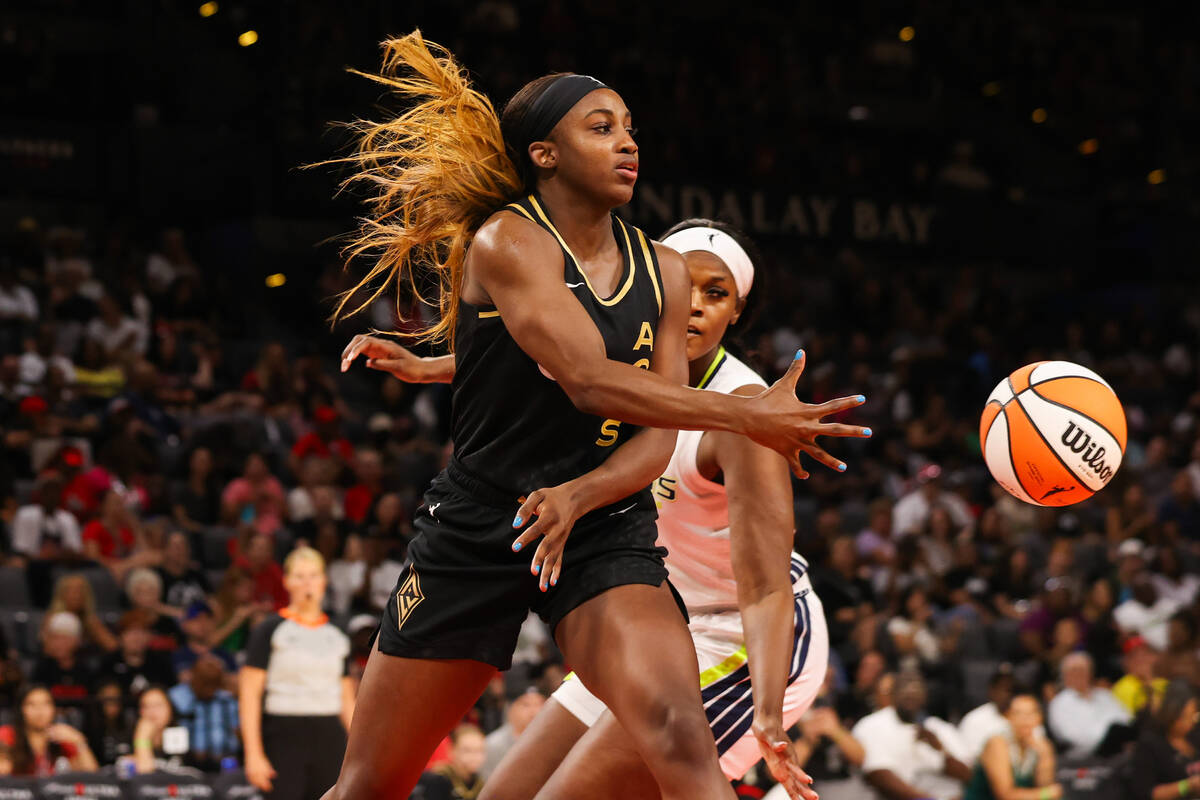 Las Vegas Aces guard Jackie Young (0) passes the ball across the court during a WNBA basketball ...