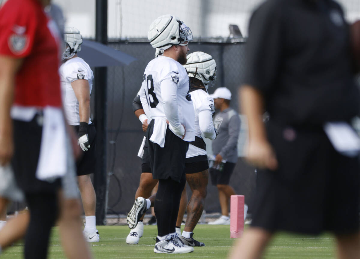 Raiders center Andre James (68) listens to his coach during training camp at the Intermountain ...