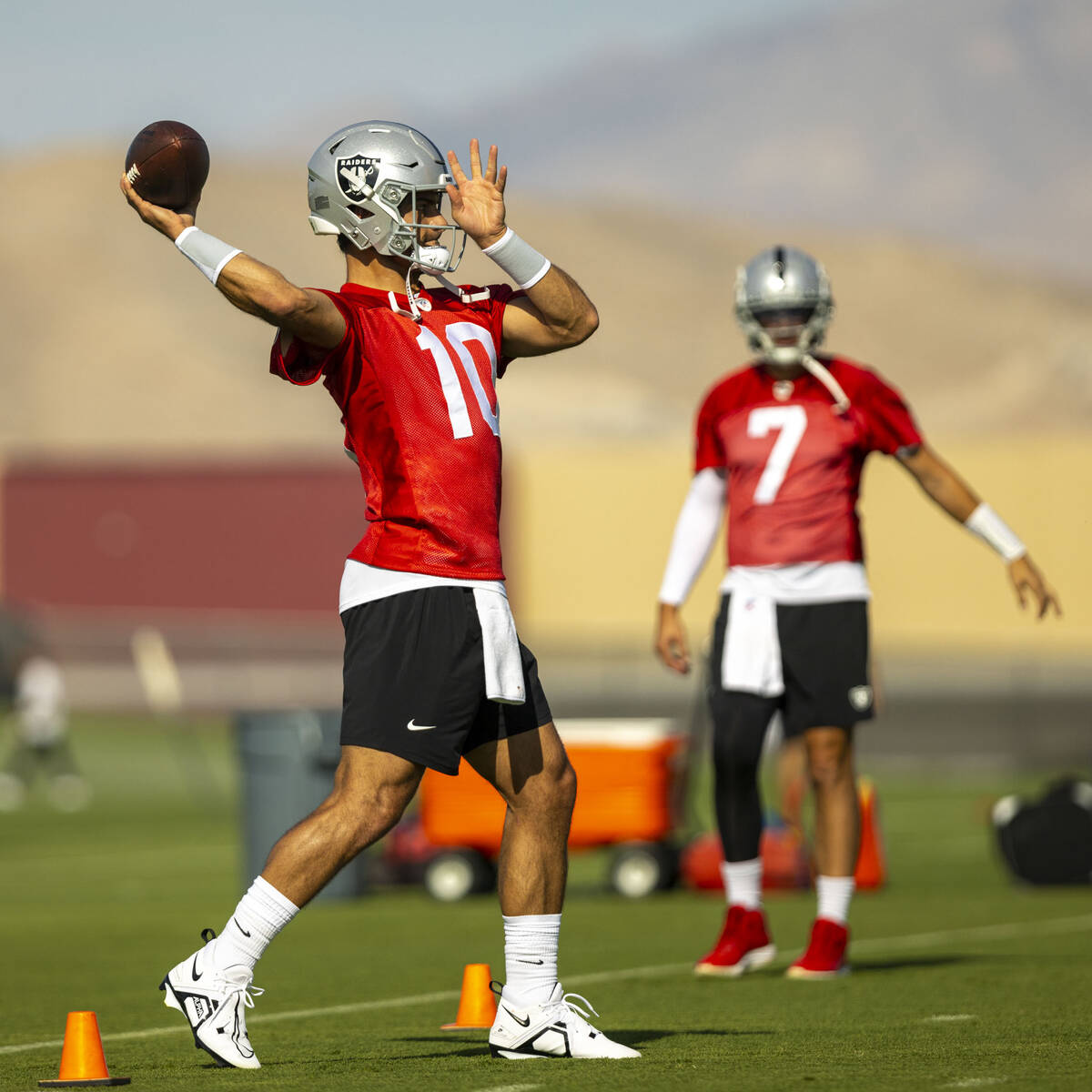 Raiders quarterback Jimmy Garoppolo throws the ball during a youth football camp as part of Fan ...