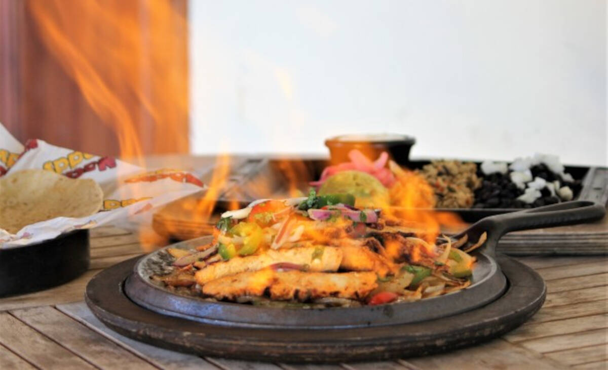 Flaming fajitas, a signature dish at Nacho Daddy in Las Vegas, are doused in tequila to create ...