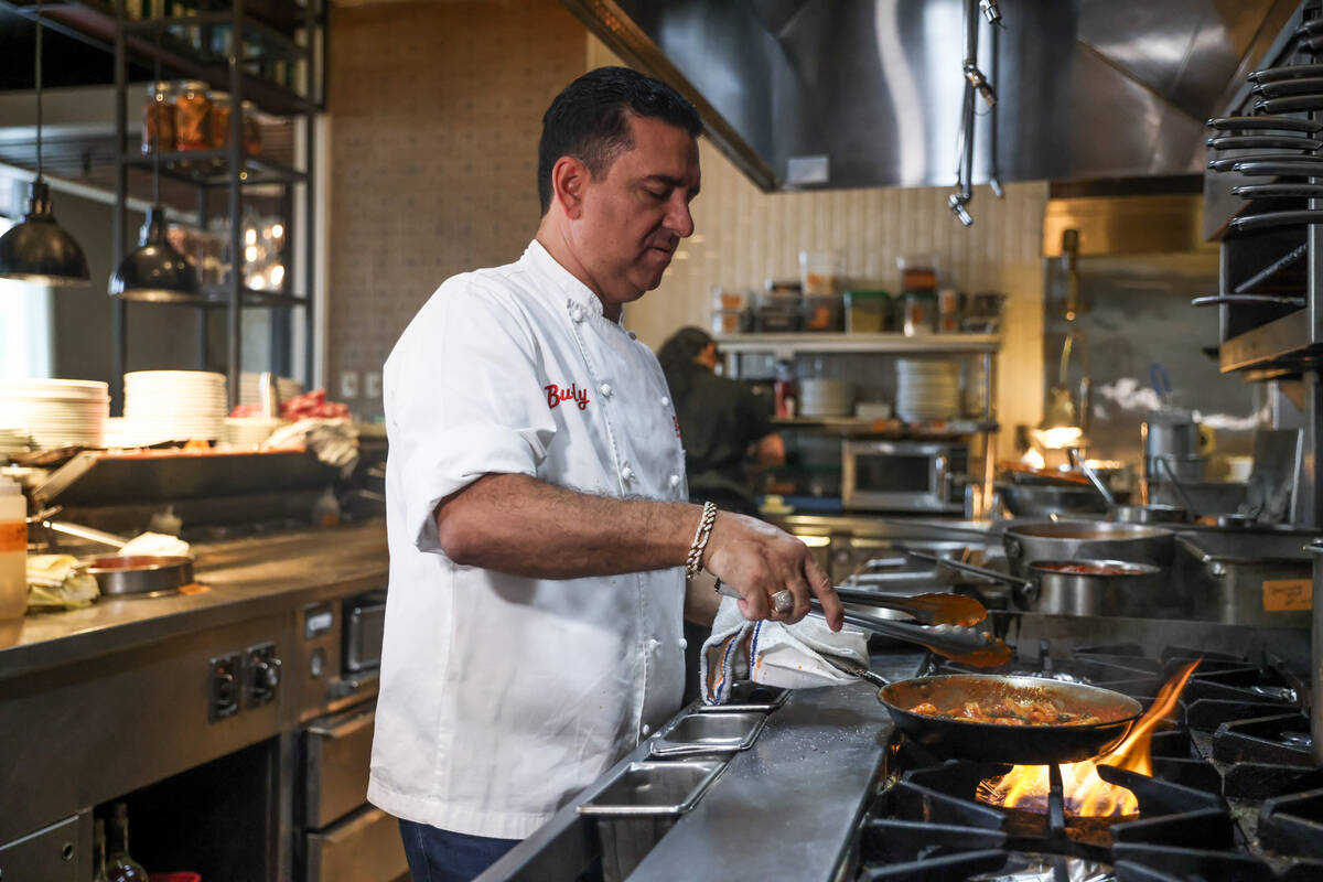 Buddy Valastro, of "Cake Boss" TV show fame, cooks a pasta dish at his restaurant, Buddy V’s ...