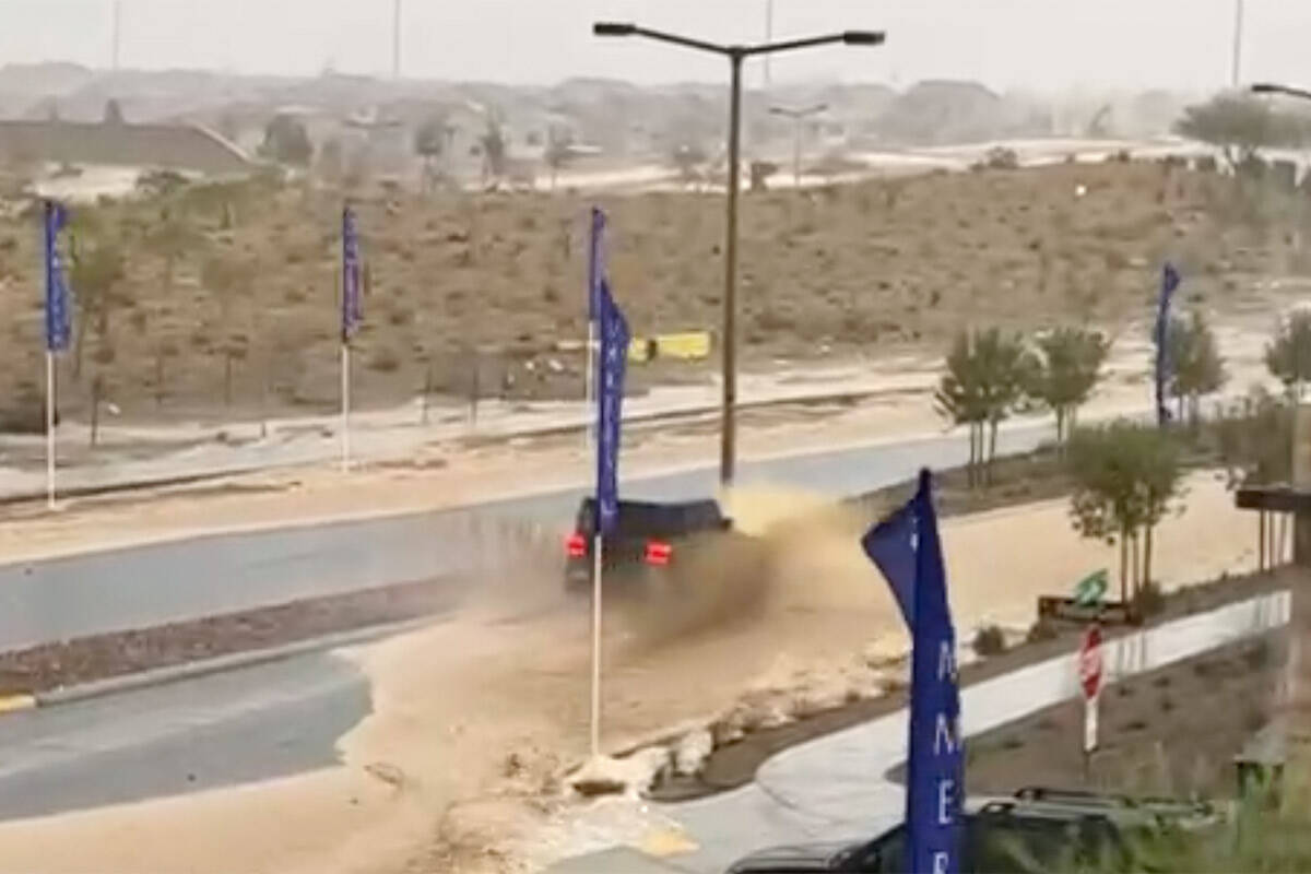 A car drives on a flooded road in Summerlin West amid heavy rain on Tuesday, Aug. 1, 2023. (Biz ...