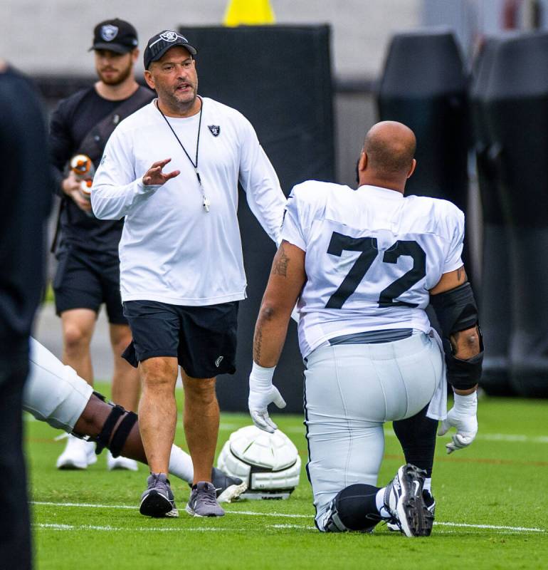 Raiders special teams coach Tom McMahon has some words for guard/tackle Jermaine Eluemunor (72) ...