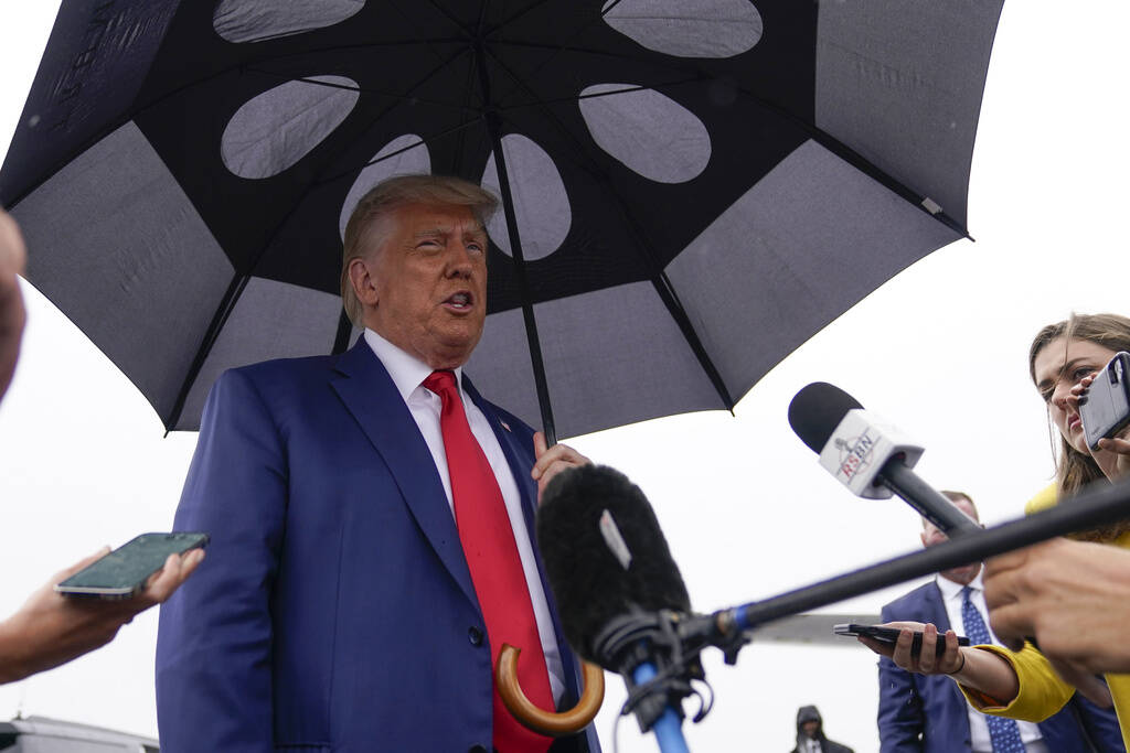 Former President Donald Trump speaks before he boards his plane at Ronald Reagan Washington Nat ...