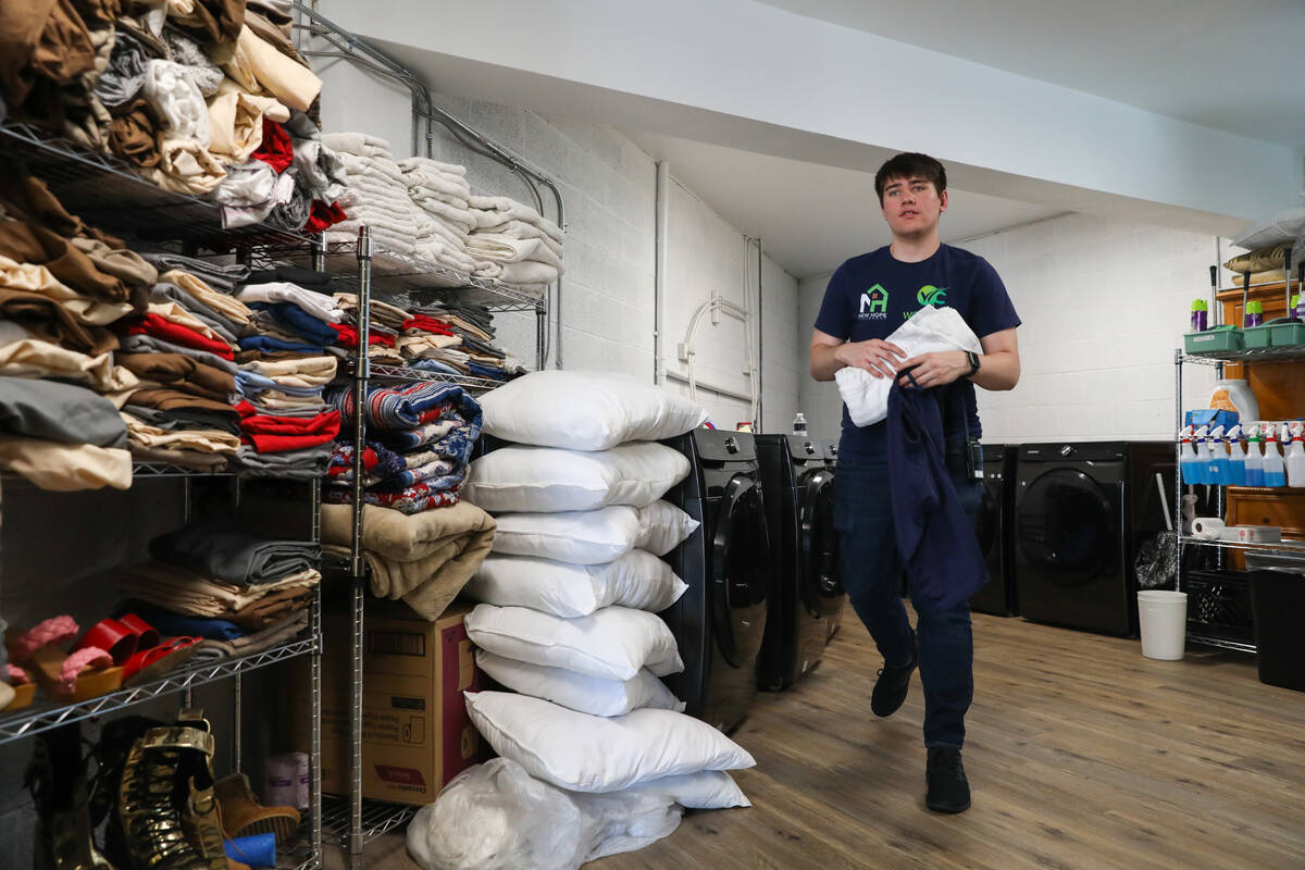 Dominick Sachs, support staff with WC Health, carries towels to an occupant at the grand openin ...