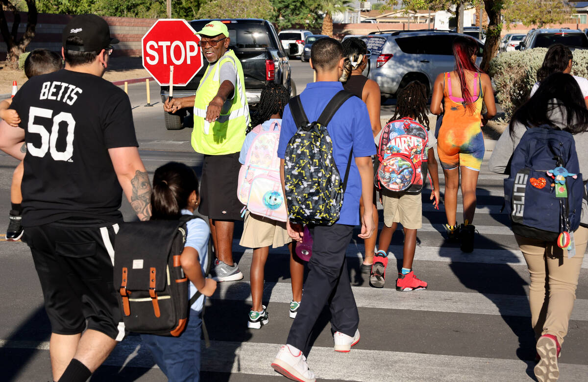 Crossing guard Mylers Thompson gets students to Democracy Prep in Las Vegas on the first day of ...