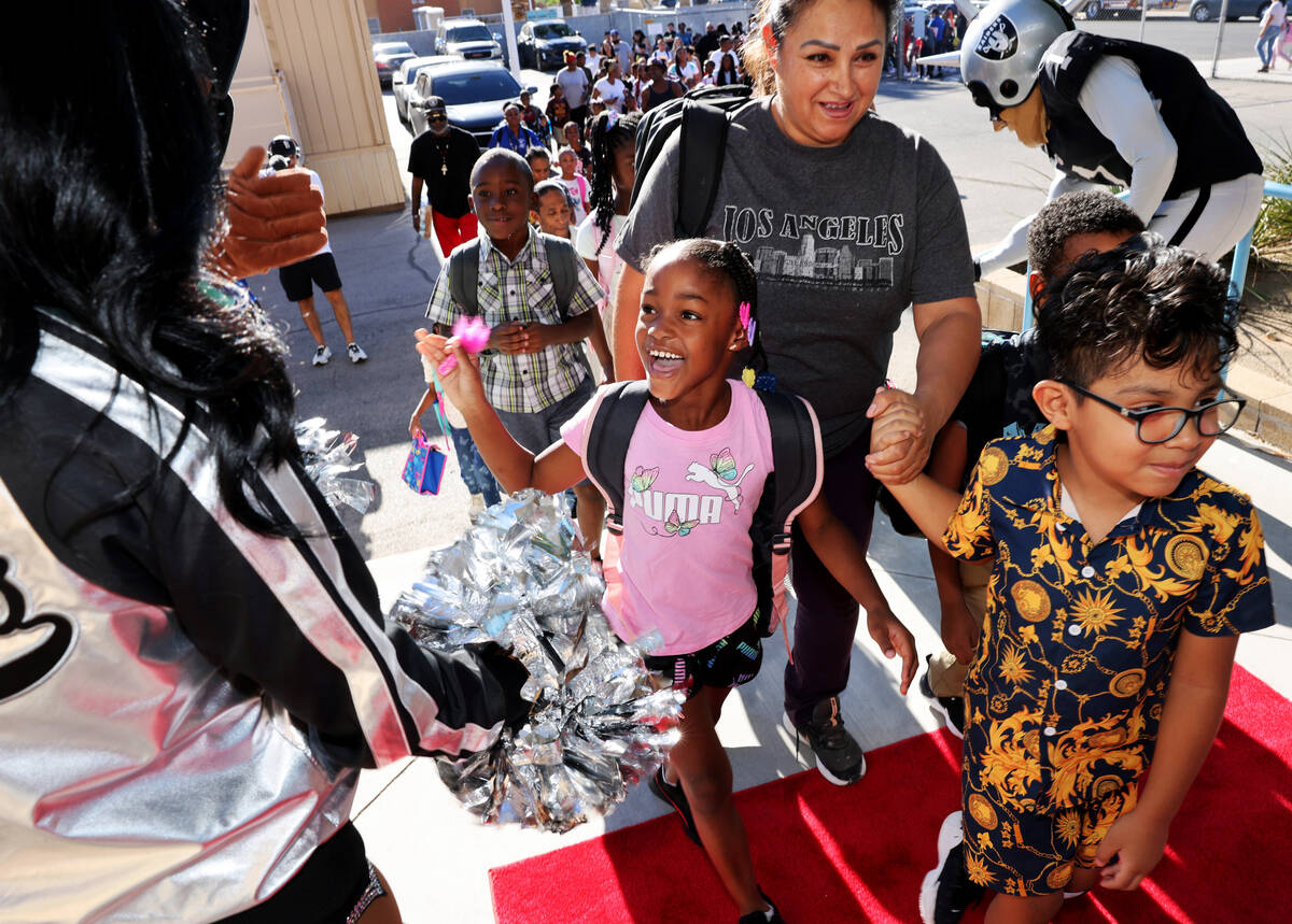 Second grader Janiya Doebine walks the red carpet during the annual “Welcome Back to Sch ...