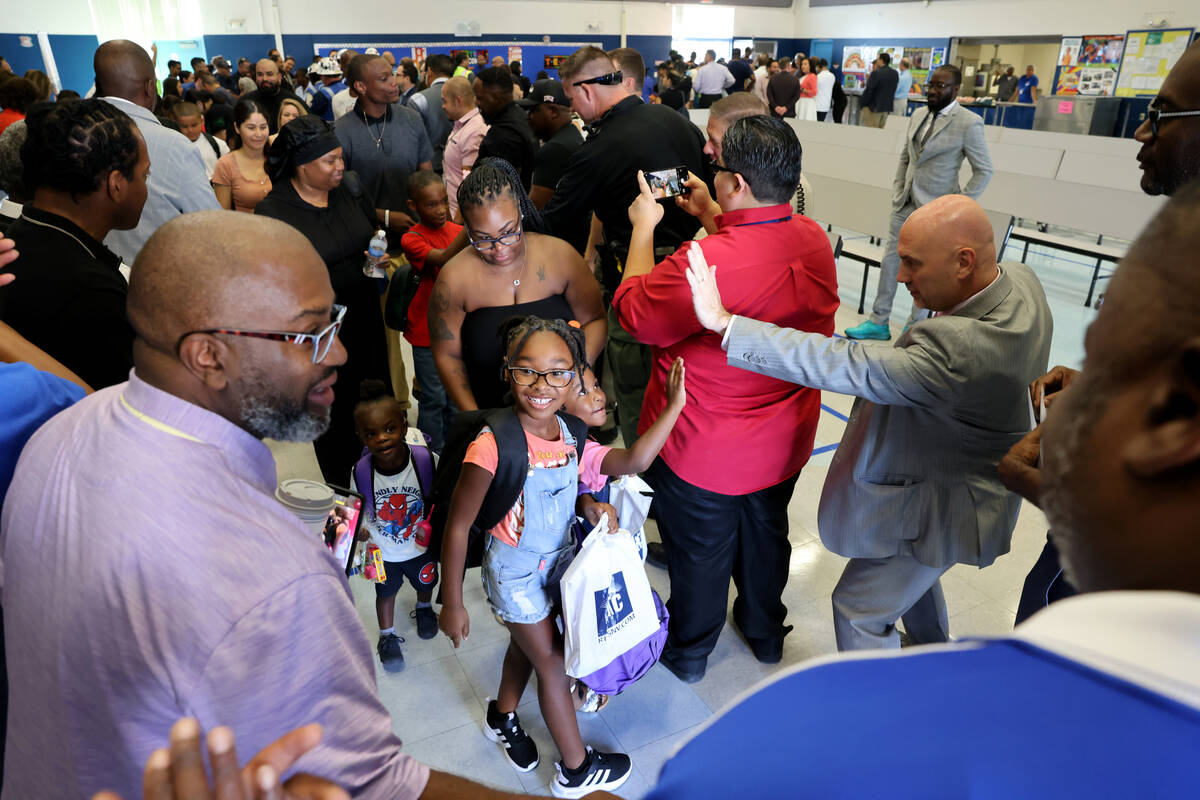 Students, including second grader Jayla Haskins, center walk the red carpet at the annual &#x20 ...