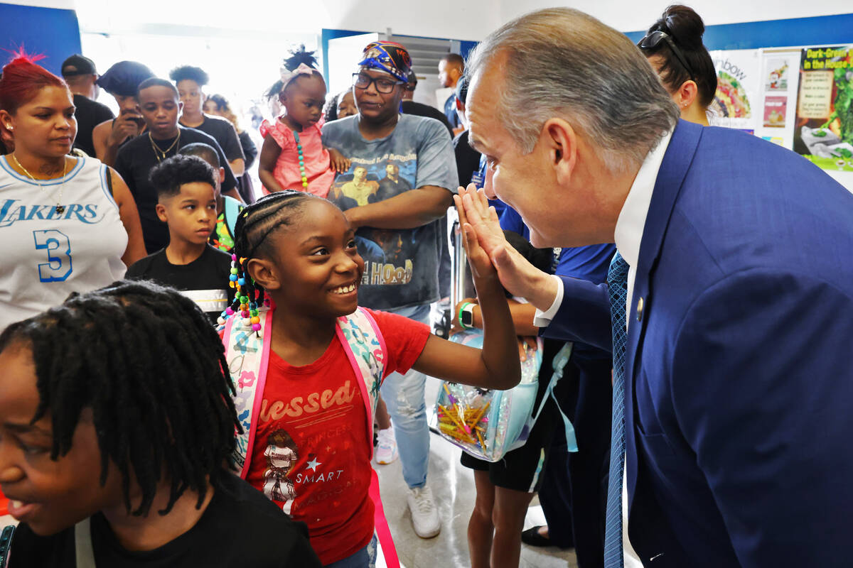 Third grader Zamiha Hunt greets Clark County School Superintendent Jesus Jara during the annual ...