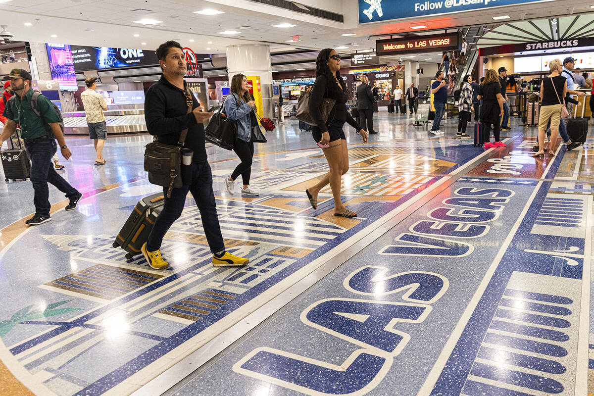 Arriving passengers head to baggage claim area in Terminal 1 of Harry Reid International Airpor ...