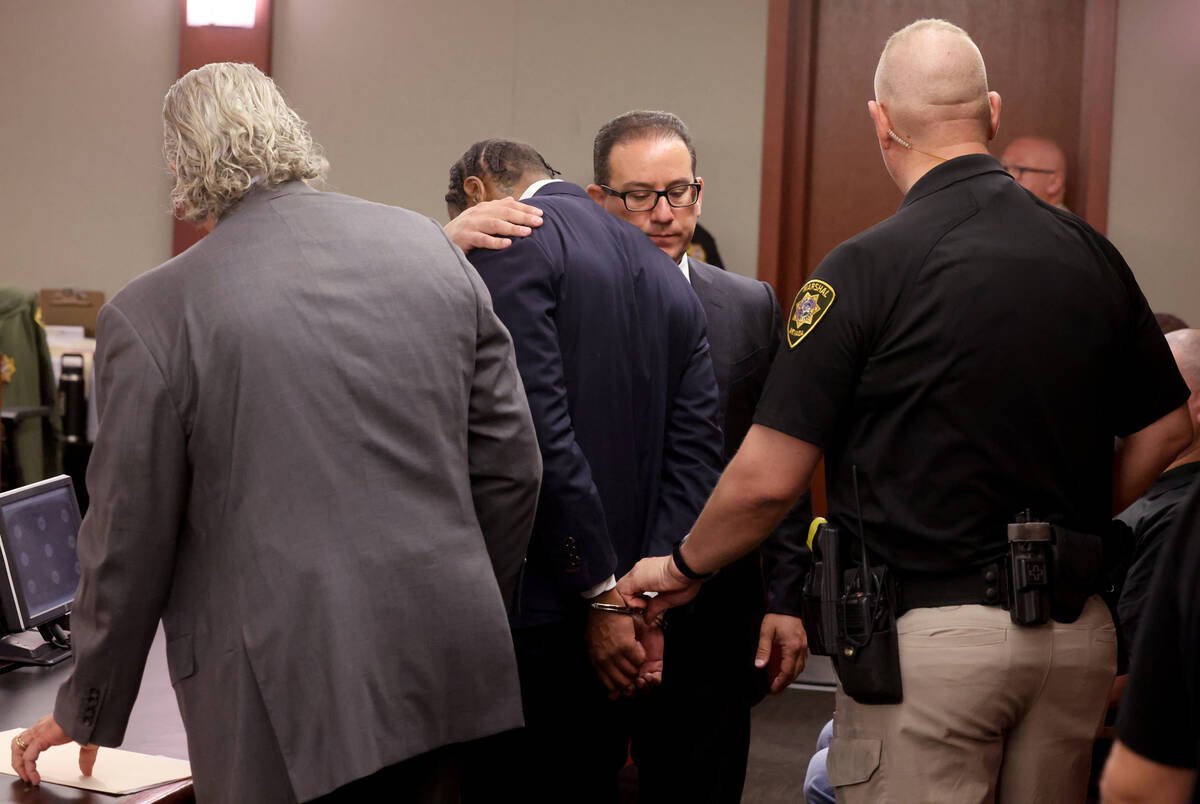 Former Raiders wide receiver Henry Ruggs is comforted by his attorneys David Chesnoff, left, an ...
