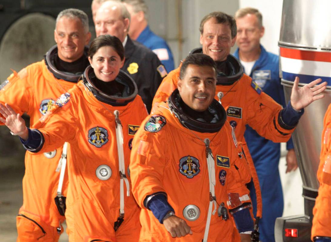 Space shuttle Discovery crew right to left: mission specialist Jose Hernandez, mission speciali ...