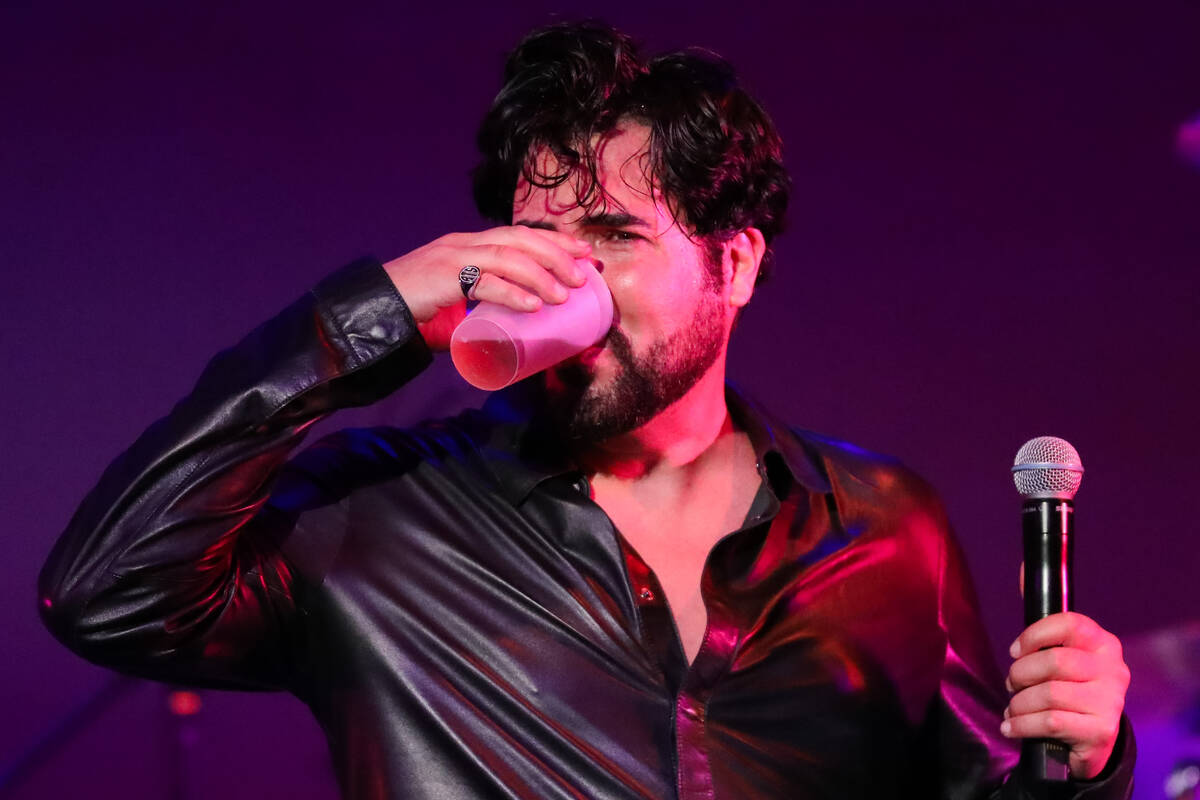 Frankie Moreno takes a quick break between songs and enjoys some whiskey during his show, The K ...