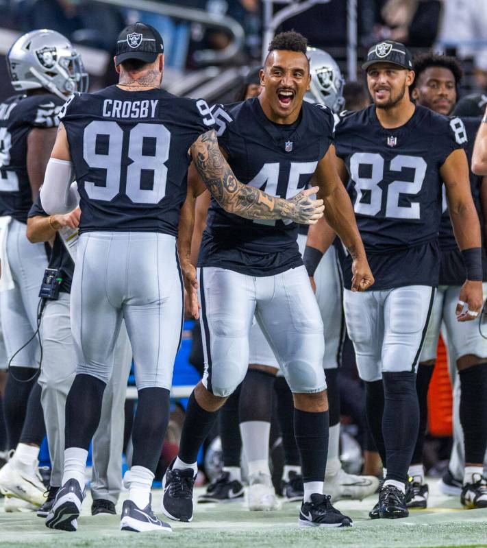 Raiders defensive end Maxx Crosby (98) and Raiders fullback Jakob Johnson (45) have fun on the ...