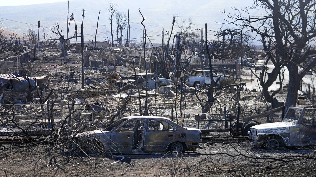 Destroyed homes and cars are shown, Sunday, Aug. 13, 2023, in Lahaina, Hawaii. Hawaii officials ...