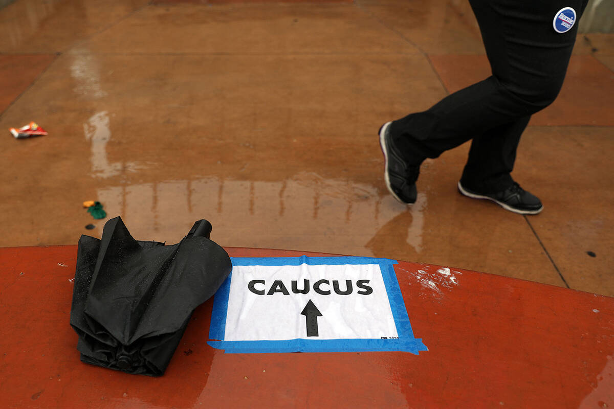 Rain falls as individuals arrive to register for the caucus at the East Las Vegas Community Cen ...