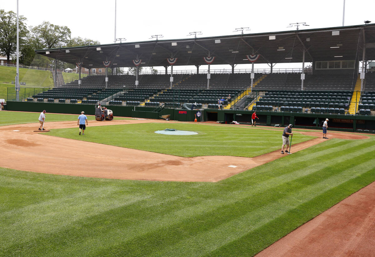 Ground crews workers prepare the field for the Little League World Series at Howard J. Lamade S ...