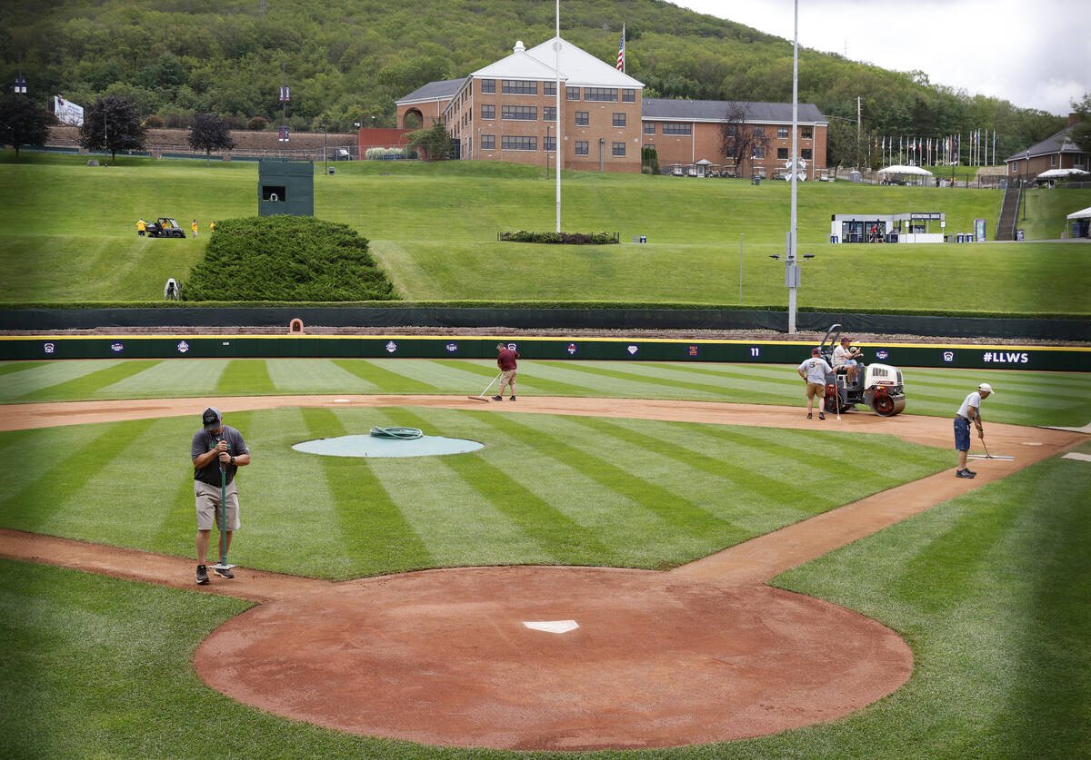 Ground crews workers prepare the field for the Little League World Series at Howard J. Lamade S ...