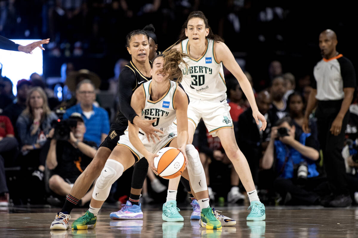 Las Vegas Aces forward Alysha Clark (7) defends against New York Liberty guard Sabrina Ionescu ...