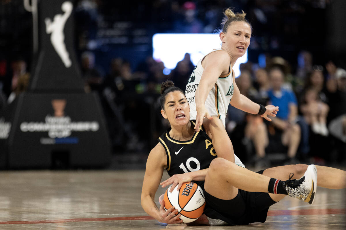 Las Vegas Aces guard Kelsey Plum (10) and New York Liberty guard Courtney Vandersloot (22) stru ...