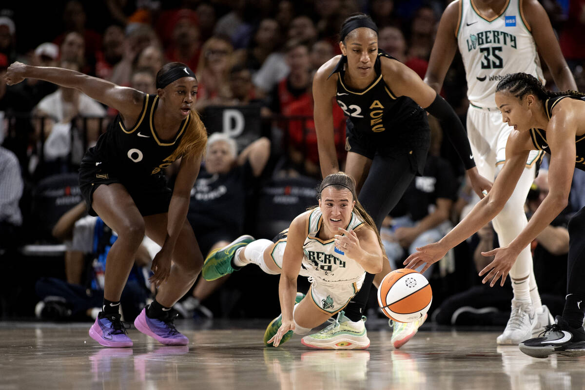 New York Liberty guard Sabrina Ionescu (20) dives for the ball while Las Vegas Aces guard Jacki ...