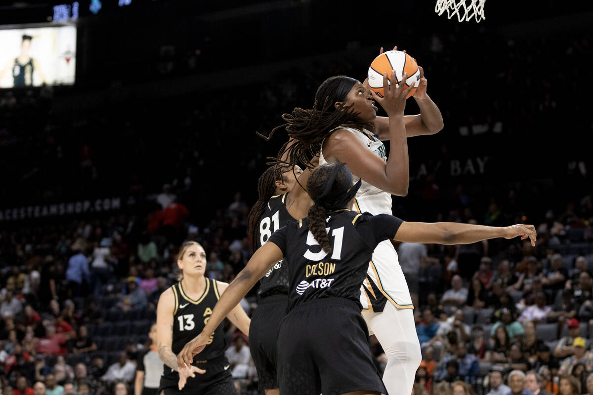 New York Liberty forward Jonquel Jones (35) shoots against Las Vegas Aces center Alaina Coates ...