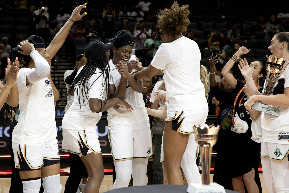 The New York Liberty congratulate forward Jonquel Jones, center left, after she was awarded Mos ...