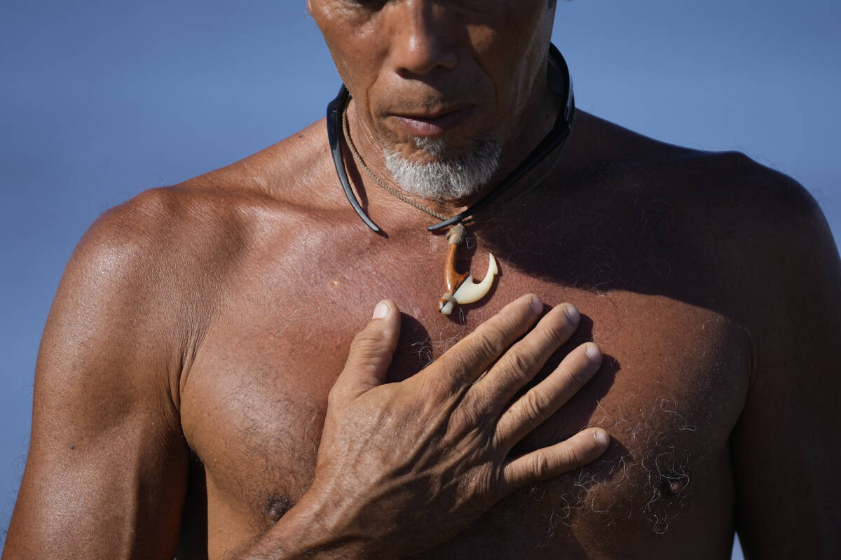 Vicente Ruboi stands on the shoreline after performing a blessing to greet the day, Tuesday, Au ...