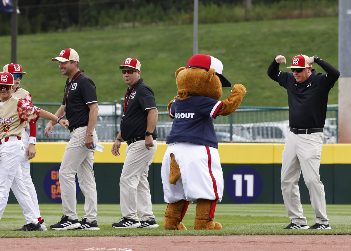 Henderson All-Stars assistant coach Arlie Daniel, right, and Dugout, the official mascot of Lit ...
