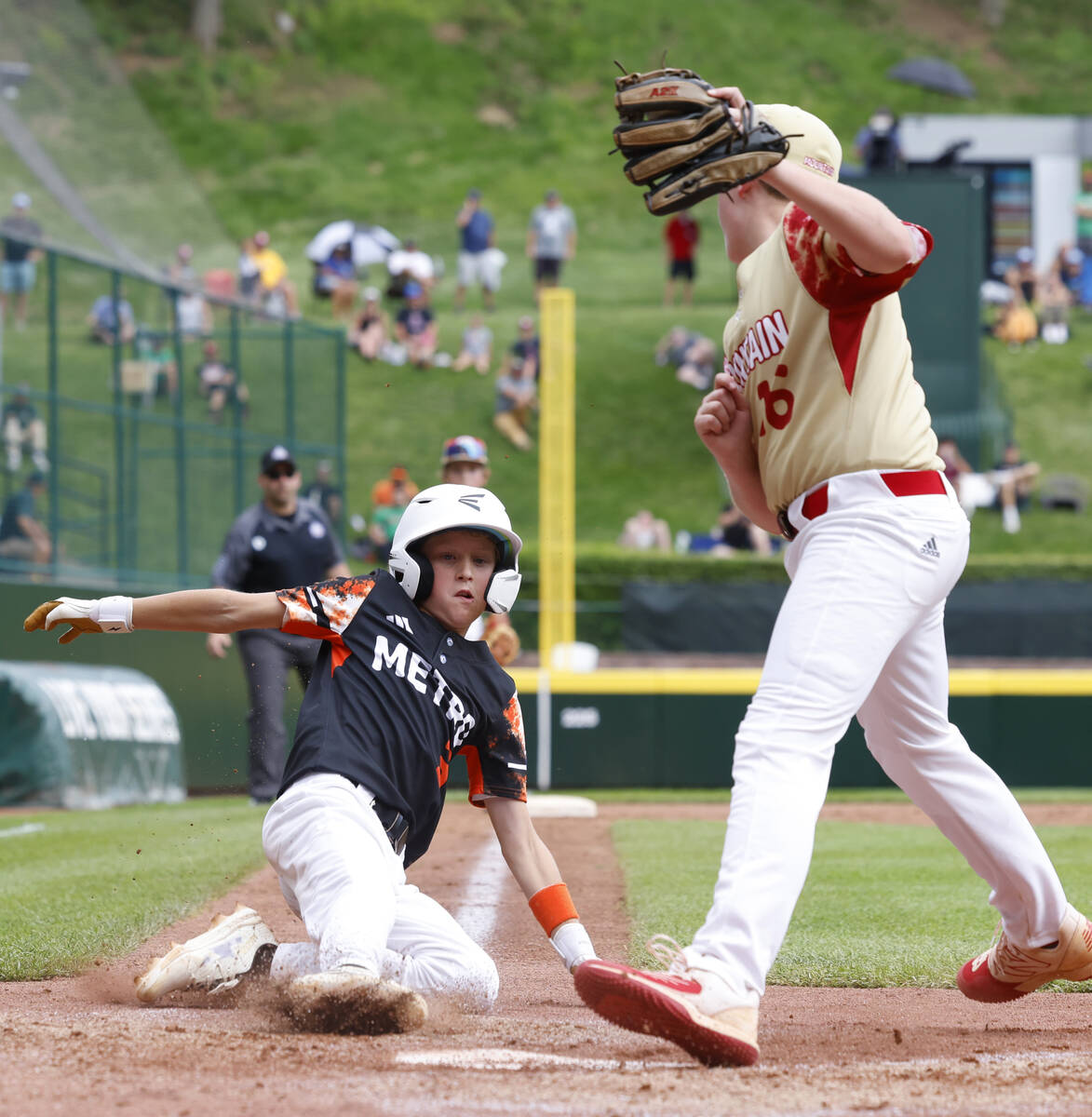 Rhode Island's Brady McShane (3) beats a throw and scores before Henderson All-Stars pitcher Lo ...