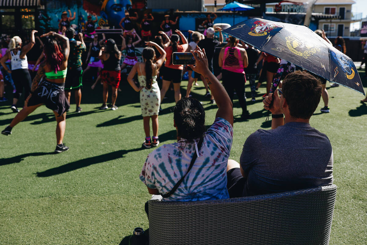 People watch a Hawaiian themed Zumba class at Container Park on Sunday, Aug. 27, 2023, in Las V ...