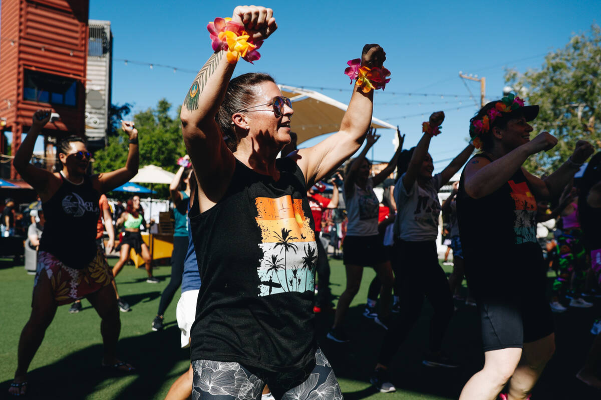 People participate in a Hawaiian themed Zumba session during a fundraiser for victims of the Ma ...