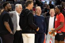 Las Vegas Aces guard Jackie Young (0) laughs with football quarterback Tom Brady, center, durin ...