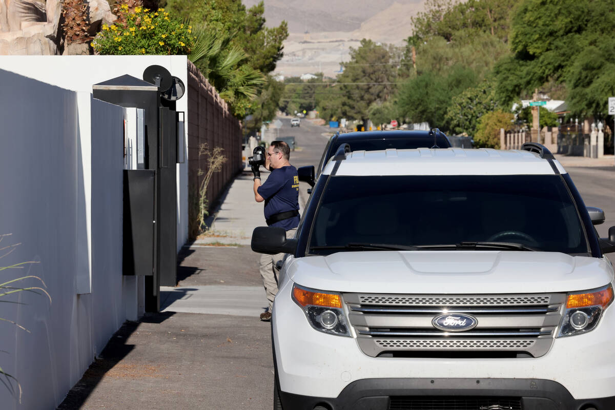 FBI personnel investigate at a home on the corner of West La Madre Way and Conough Lane in Las ...